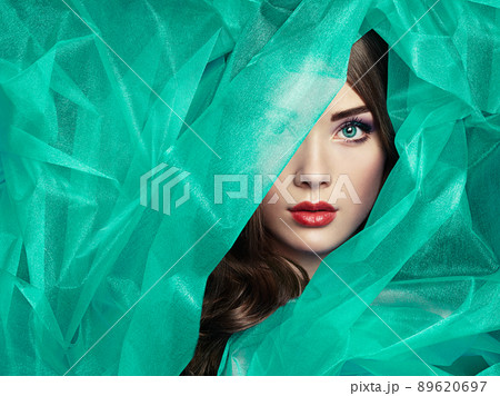 Fashion photo of beautiful women under turquoise veil 89620697
