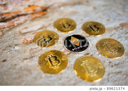 Close up one golden coin and silver coin with the bitcoin symbol and ethereum symbol. Close up one golden coin and silver coin with the bitcoin symbol and ethereum symbol. 89621374