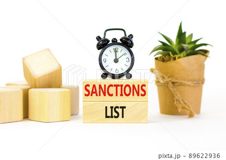 Sanctions list symbol. Wooden blocks with concept words Sanctions list on beautiful white background. Black alarm clock. Business political sanctions list concept. Copy space. Sanctions list symbol. Wooden blocks with concept words Sanctions list on beautiful white background. Black alarm clock. Business political sanctions list concept. Copy space. 89622936