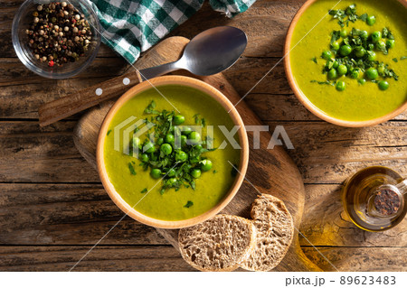 Green pea soup in a wooden bowl Green pea soup in a wooden bowl 89623483