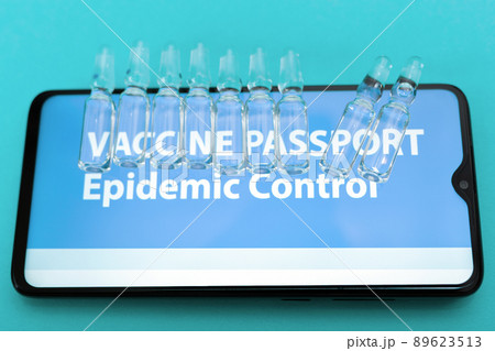 Close up view of smartphone screen with vaccines and electronic Immunity passport. Blue background. Top view. Concept of vaccination from COVID-19 Close up view of smartphone screen with vaccines and electronic Immunity passport. Blue background. Top view. Concept of vaccination from COVID-19 89623513