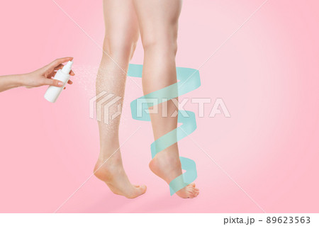 A woman stands on her toes, and a cosmetic product is sprayed on her shins. Copy space. A blue ribbon curls around the leg. Pink background. The concept of health, freshness and beauty of the legs A woman stands on her toes, and a cosmetic product is sprayed on her shins. Copy space. A blue ribbon curls around the leg. Pink background. The concept of health, freshness and beauty of the legs 89623563