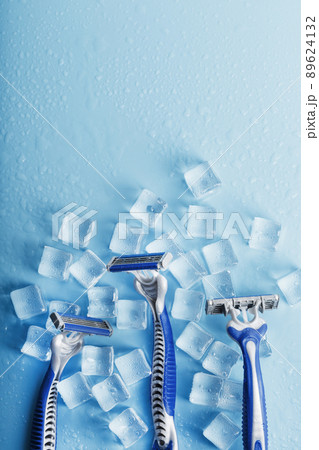 Three shaving machines on a frosty blue background with ice. The concept of cleanliness and frosty freshness 89624132