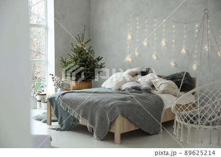 Elegant bedroom interior with little decorated Christmas tree 89625214