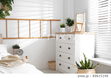 White chest of drawers in beautiful bedroom. Interior design White chest of drawers in beautiful bedroom. Interior design 89625246