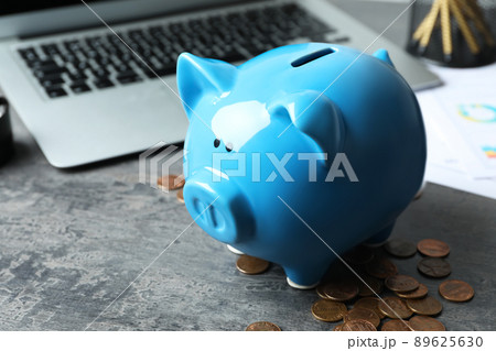 Blue piggy bank and money on grey table, closeup 89625630