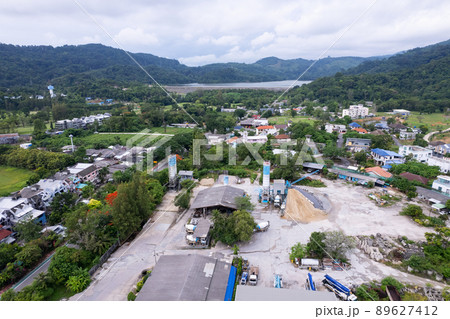 Aerial view top down of Visible cement storage towers and concrete mixing machines.heap of sand and gravel. Industrial background concept Aerial view top down of Visible cement storage towers and concrete mixing machines.heap of sand and gravel. Industrial background concept 89627412