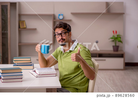Young male student studying at home Young male student studying at home 89628560