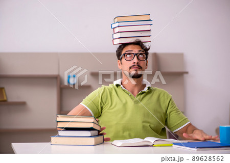 Young male student studying at home 89628562