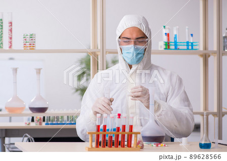 Young male chemist sitting at the lab during pandemic Young male chemist sitting at the lab during pandemic 89628566