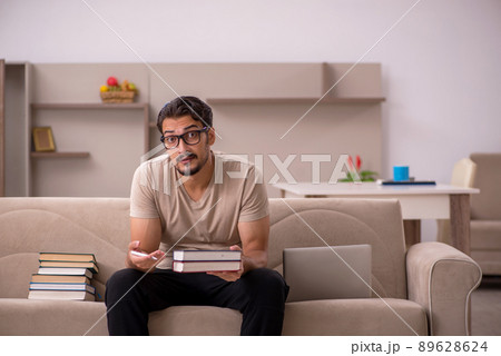 Young male student studying at home during pandemic Young male student studying at home during pandemic 89628624
