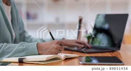 E-learning Online Education concept. Asian woman attentive student student video conference e-learning with teacher on laptop computer at home. 89631438