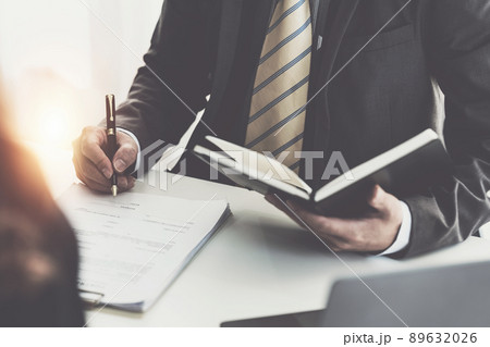 Business woman and lawyers discussing contract papers with brass scale on wooden desk in office. Law, legal services, advice, Justice concept. Business woman and lawyers discussing contract papers with brass scale on wooden desk in office. Law, legal services, advice, Justice concept. 89632026