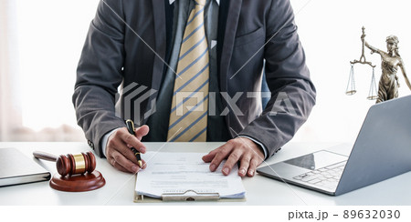 Close up lawyer businessman working or reading contract in office workplace for consultant lawyer concept. Law, legal services, advice, Justice concept. 89632030