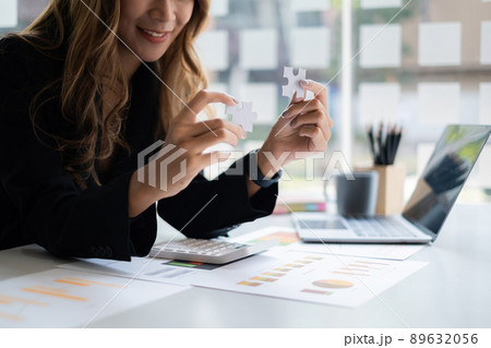 Closeup hand of Business woman connecting jigsaw puzzle. Finance and strategy and success concept. Closeup hand of Business woman connecting jigsaw puzzle. Finance and strategy and success concept. 89632056