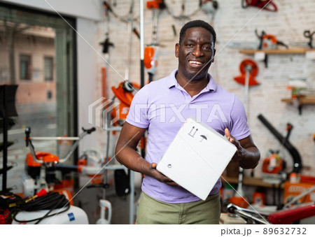 African-american man with box in gardening tools shop African-american man with box in gardening tools shop 89632732