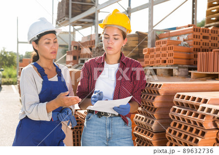 Female workers having conversation in outdoot warehouse 89632736