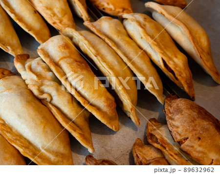 Rows of fresh, just baked empanadas 89632962
