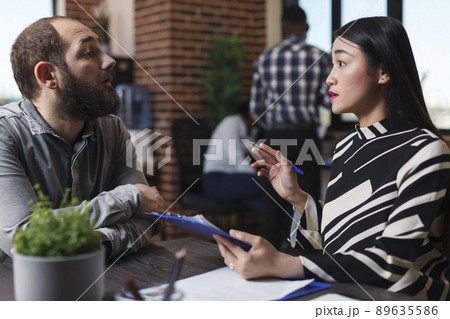 Executive manager interviewing worker applicant recruiting for hr job discussing business offer in startup office. Businesswoman hiring candidate after checking cv resume. Recruitment concept Executive manager interviewing worker applicant recruiting for hr job discussing business offer in startup office. Businesswoman hiring candidate after checking cv resume. Recruitment concept 89635586