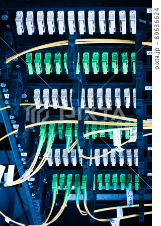 Fiber Optic cables connected to an optic ports - data switch in internet data center 89636624