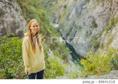 Woman tourist in the background of Beautiful Canyon of Moraca river in winter, Montenegro or Crna Gora, Balkan, Europe Woman tourist in the background of Beautiful Canyon of Moraca river in winter, Montenegro or Crna Gora, Balkan, Europe 89641318