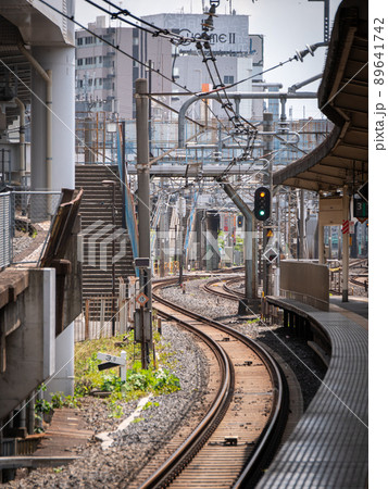 Passenger train station with s shaped rails and wires in Japan 89641742