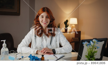 Beautiful Italian female doctor in uniform smiles in her office 89641806