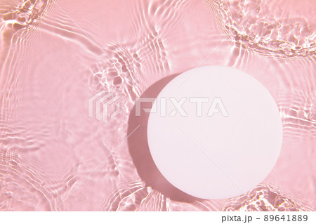 Empty white circle podium on transparent pink clear water background Empty white circle podium on transparent pink clear water background 89641889