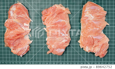 Chicken thigh ,leg meat on a line board. Raw skinless boneless chicken thigh, for cooking. Chicken thigh ,leg meat on a line board. Raw skinless boneless chicken thigh, for cooking. 89642752