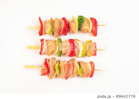 skewers of raw meat and vegetables.Frozen pieces of chicken skewers fillet with vegetables on an white background.Chicken fresh skewers meat. 89642776
