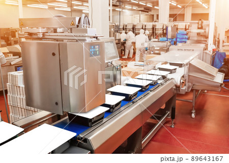 Line for the production meat with packaging and cutting. Industrial equipment at a meat factory.Meat processing plant.Working factory line.Food industry chicken.Production line of meat. 89643167