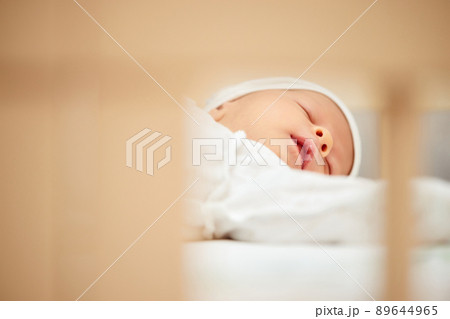 adorable new born baby sleeping in bed adorable new born baby sleeping in bed 89644965