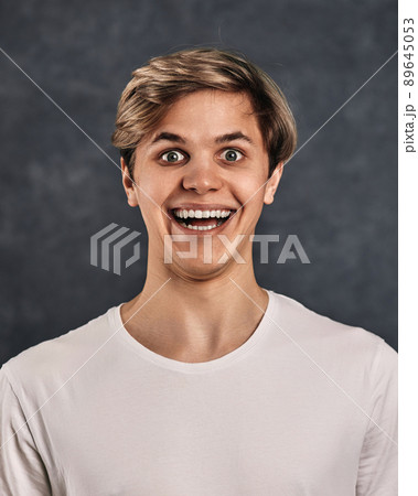 funny young handsome guy on gray background. 89645053