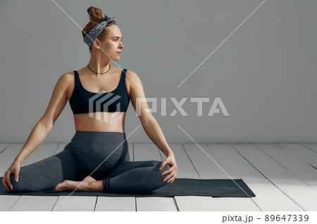 Full Body Portrait Of Pregnant Woman Doing Yoga On Exercise Mat. Isolated on gray background 89647339