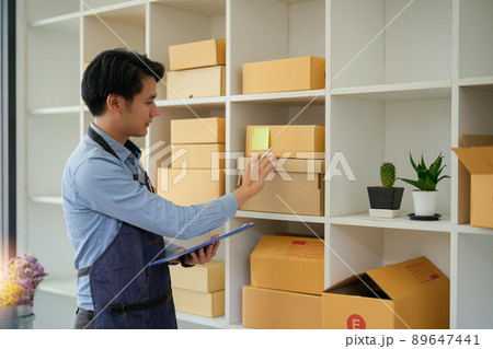 Young attractive asian owner startup business look at camera work happy with box at home prepare parcel delivery in sme supply chain, procurement, omnichannel or coronavirus quarantine concept Young attractive asian owner startup business look at camera work happy with box at home prepare parcel delivery in sme supply chain, procurement, omnichannel or coronavirus quarantine concept 89647441