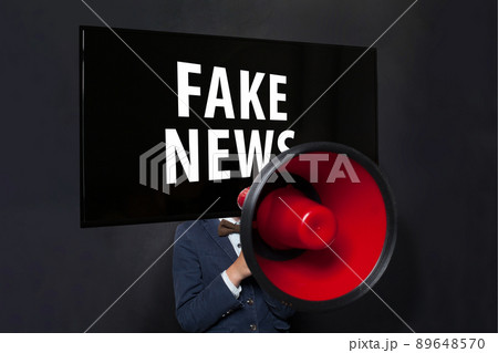 Man with red loudspeaker and tv head on black. Fake news concept. 89648570
