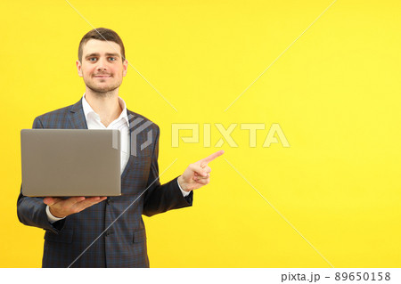 Businessman with laptop on yellow background, space for text Businessman with laptop on yellow background, space for text 89650158