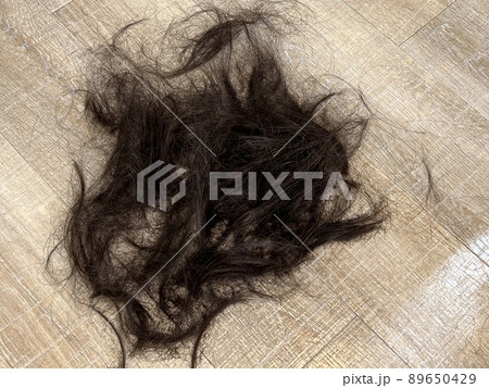 フローリングの床に散らばったカットした髪、散髪した髪の毛 89650429