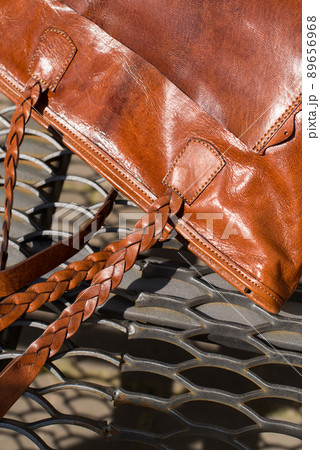 close-up photo of orange leather bag on a metal texture background 89656968