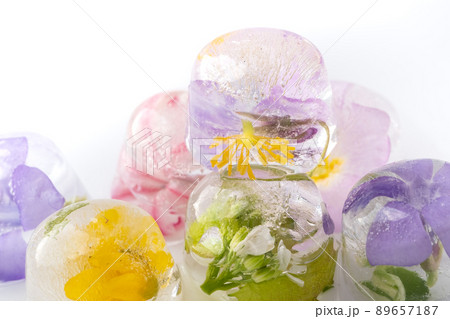 Ice cubes with frozen flowers on a white background. flower 89657187