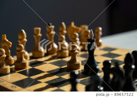 Wooden chessboard in the sun. Black and white. Wooden chessboard in the sun. Black and white. 89657522