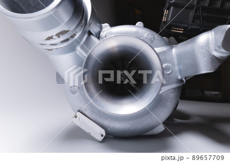 New turbocharger with aluminum cold section. on a gray contrasting background. car engine turbocharger. spare parts 89657709