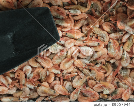 Frozen sea prawns in the refrigerator in the store 89657944