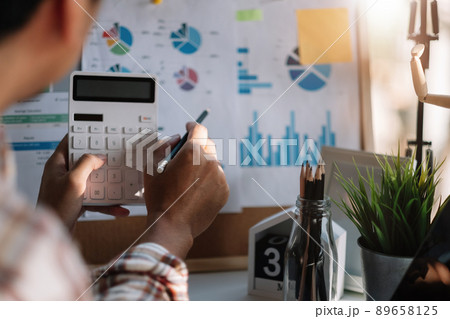 Accountant man calculator and laptop for calaulating finance, tax, accounting, statistics and analytic research concept. 89658125