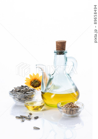 Sunflower oil and sunflower seeds isolated on white background with copyspace. Vertical format. 89658494