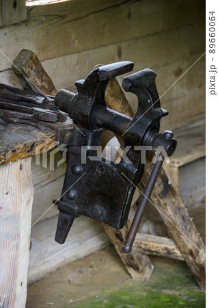 a vintage bench vise in the blacksmith workshop in reconstruction of ukrainian village of 19th century a vintage bench vise in the blacksmith workshop in reconstruction of ukrainian village of 19th century 89660064