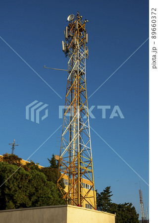 Radio transmitting TV tower with transmitters against the blue sky. Radio transmitting TV tower with transmitters against the blue sky. 89660372