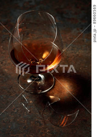 Brandy is in broken glass on a rusty background. 89660569