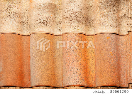 Texture of a wavy brown tile roof with splashes. 89661290