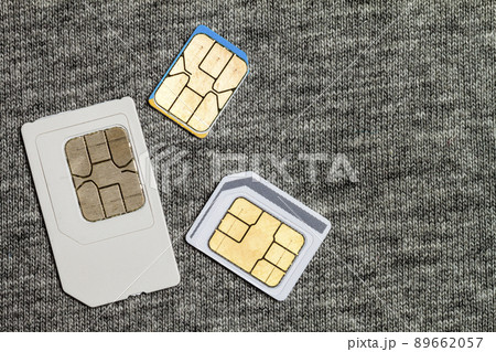 Set of mini, micro and nano simcard. Isolated on grey cloth texture background Set of mini, micro and nano simcard. Isolated on grey cloth texture background 89662057